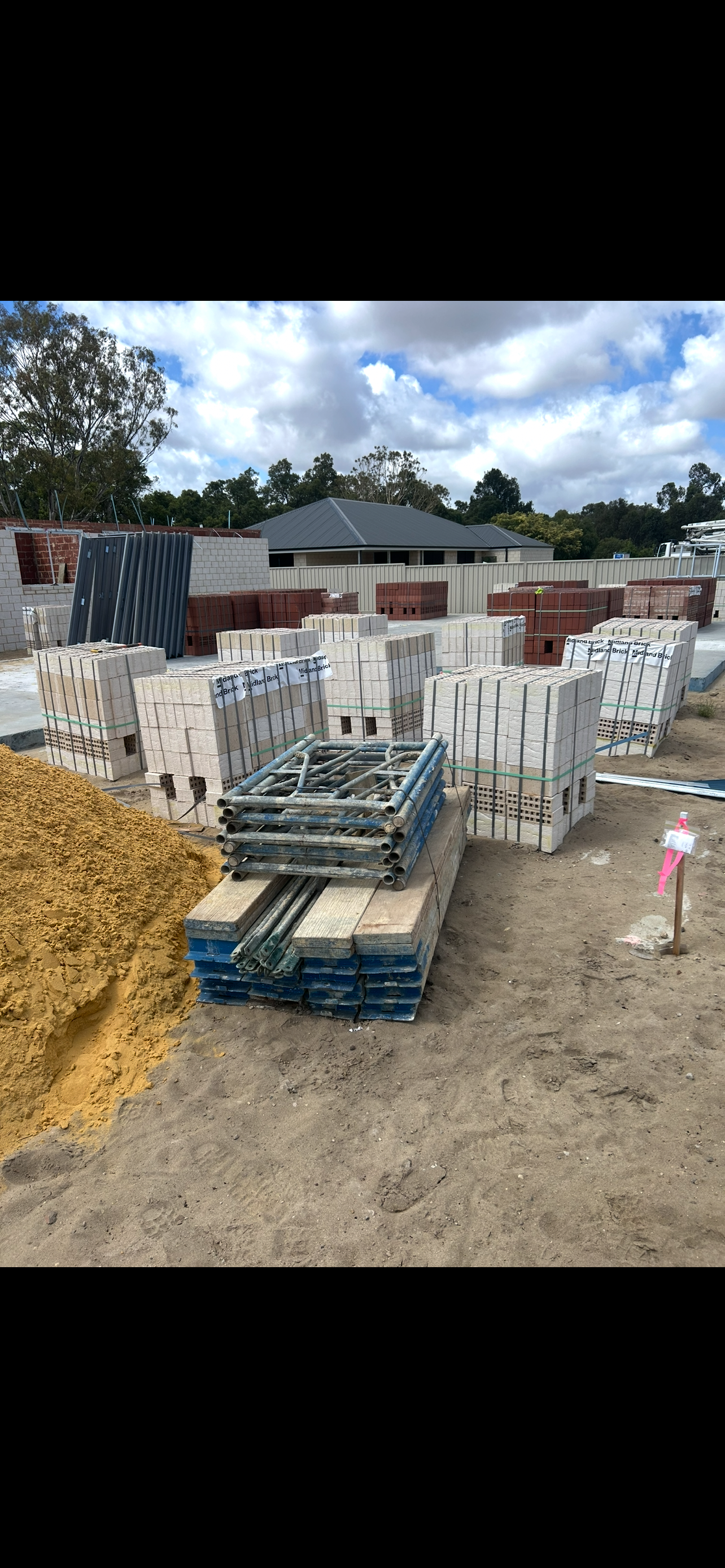 Containment Group brickies kit beside Midland Brick pallets