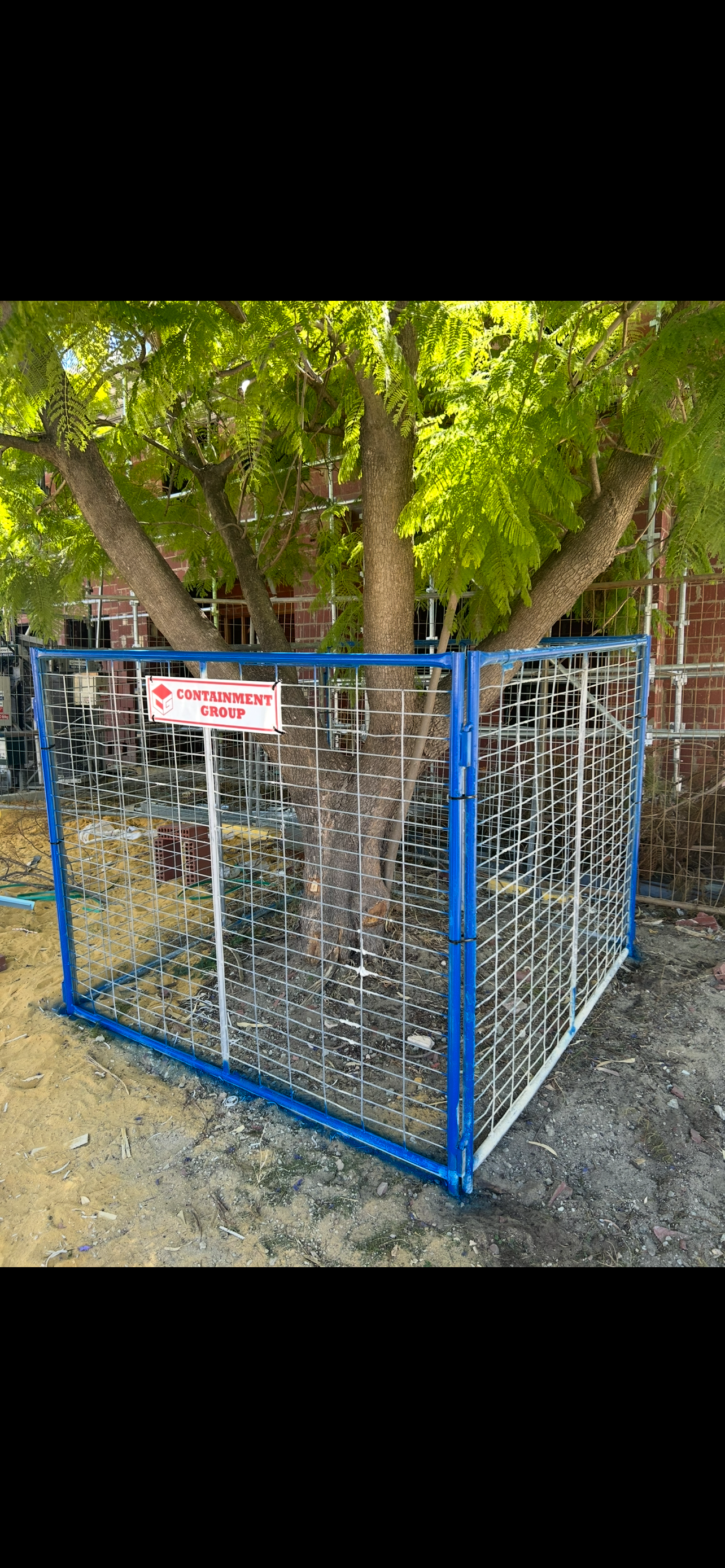 Containment Group caged tree protection installed around a mature tree on a Perth site